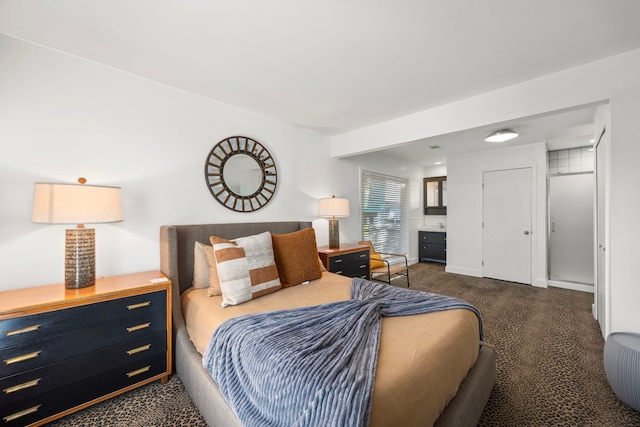 bedroom with baseboards and dark carpet