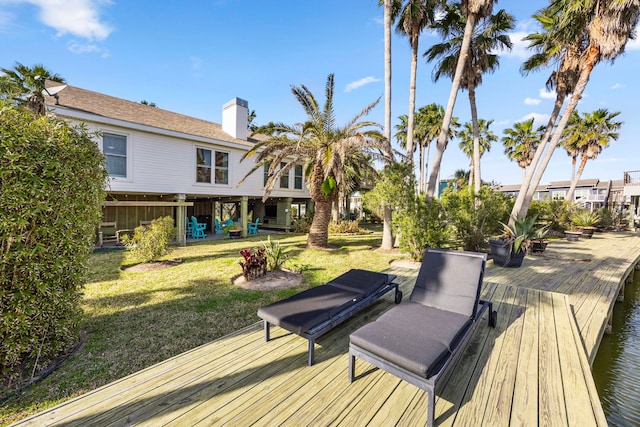 wooden terrace featuring a yard