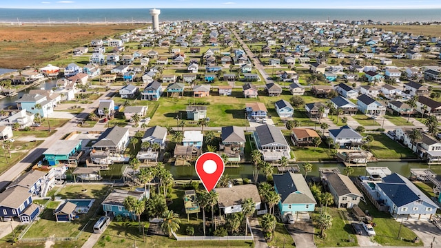 drone / aerial view featuring a residential view and a water view