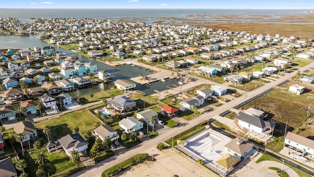 drone / aerial view featuring a water view and a residential view