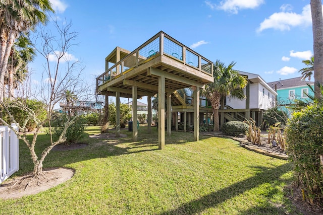 rear view of property featuring stairway, a lawn, and a wooden deck