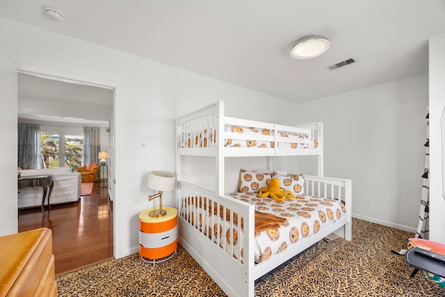 bedroom with visible vents and baseboards