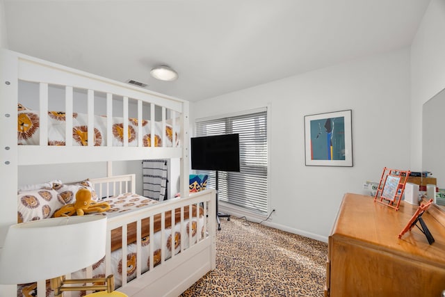 carpeted bedroom featuring visible vents and baseboards