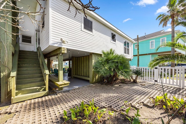 back of property featuring stairway