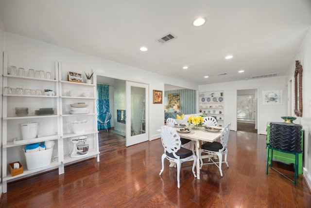 dining space featuring wood finished floors, visible vents, and recessed lighting