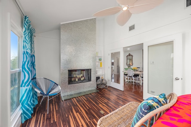 living room with french doors, visible vents, a fireplace, and wood finished floors