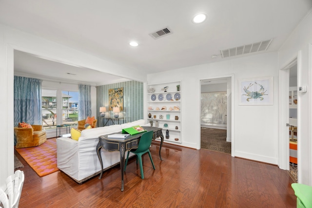 living room featuring built in features, wood finished floors, visible vents, and recessed lighting