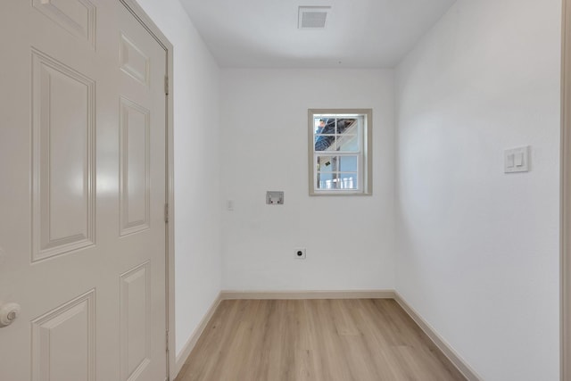 clothes washing area with visible vents, light wood-style floors, hookup for an electric dryer, laundry area, and baseboards