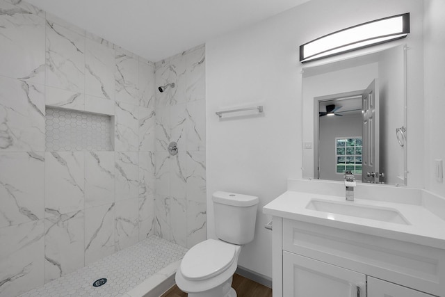 full bathroom with vanity, a shower stall, and toilet