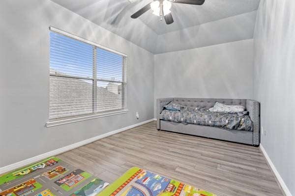 bedroom featuring light wood-style floors, baseboards, and a ceiling fan