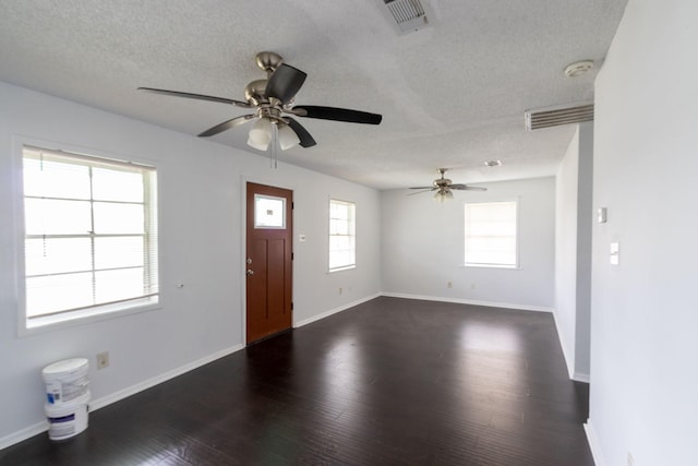 629 13th Ave N, Texas City, TX 77590 - foyer featuring dark wood-style floors, visible vents, a textured ceiling, and baseboards