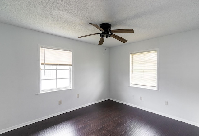 629 13th Ave N, Texas City, TX 77590 - empty room featuring a textured ceiling, dark wood finished floors, a wealth of natural light, and baseboards