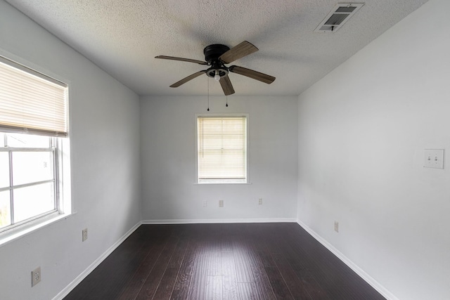 629 13th Ave N, Texas City, TX 77590 - unfurnished room featuring baseboards, plenty of natural light, visible vents, and dark wood-type flooring