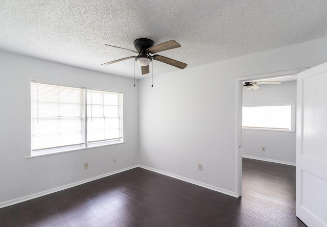 629 13th Ave N, Texas City, TX 77590 - unfurnished room featuring plenty of natural light, baseboards, ceiling fan, and dark wood-type flooring