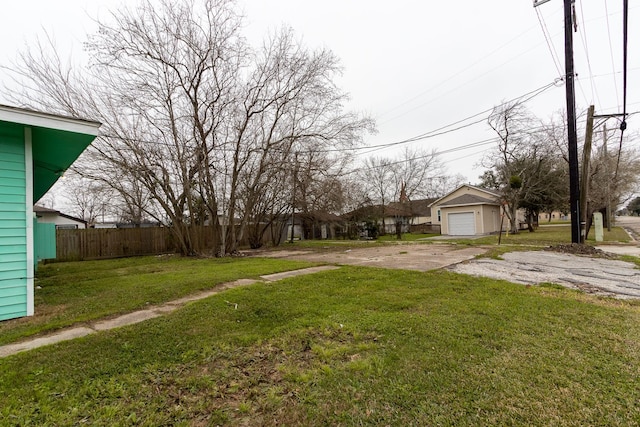 629 13th Ave N, Texas City, TX 77590 - view of yard featuring a garage, driveway, and fence