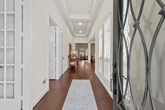 hallway featuring recessed lighting, dark wood-style flooring, a raised ceiling, and baseboards