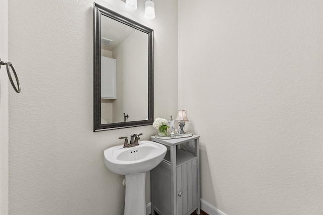 bathroom featuring visible vents and a sink