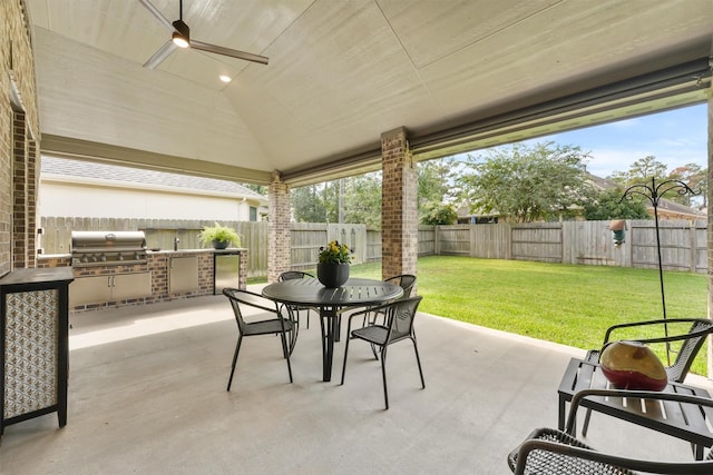 view of patio / terrace with outdoor dining area, grilling area, an outdoor kitchen, a ceiling fan, and a fenced backyard