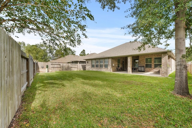 view of yard featuring a patio area and a fenced backyard