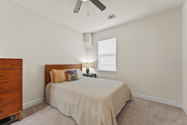 bedroom featuring baseboards, ceiling fan, visible vents, and light colored carpet