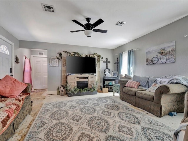 living area with ceiling fan and visible vents