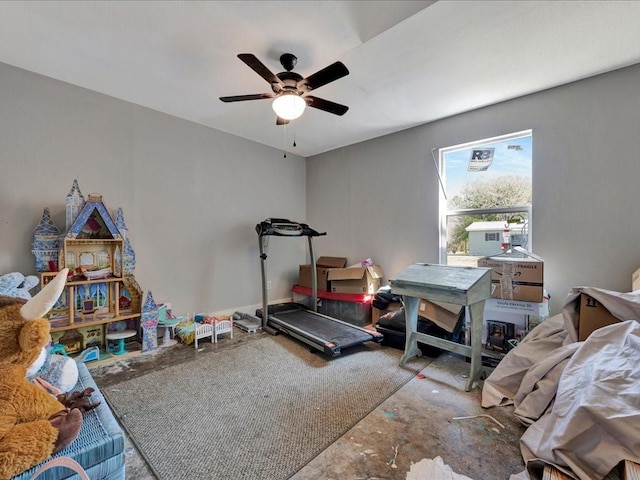 exercise room with a ceiling fan