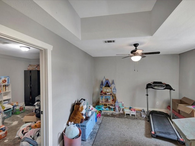 workout area with baseboards, visible vents, and a ceiling fan