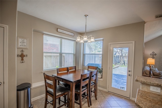 dining space with visible vents, baseboards, light tile patterned flooring, and a notable chandelier