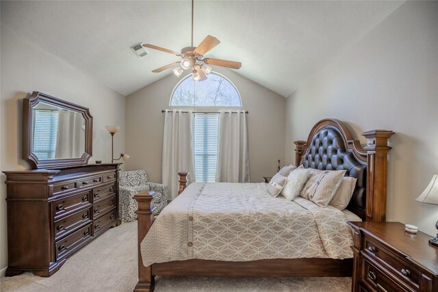 bedroom featuring ceiling fan, lofted ceiling, visible vents, and light carpet