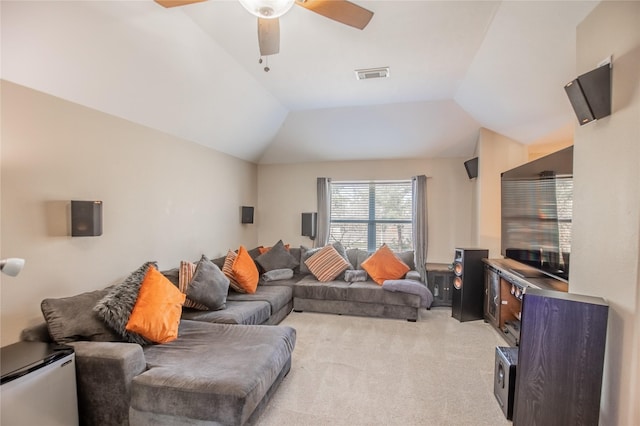 living area with ceiling fan, vaulted ceiling, visible vents, and light carpet