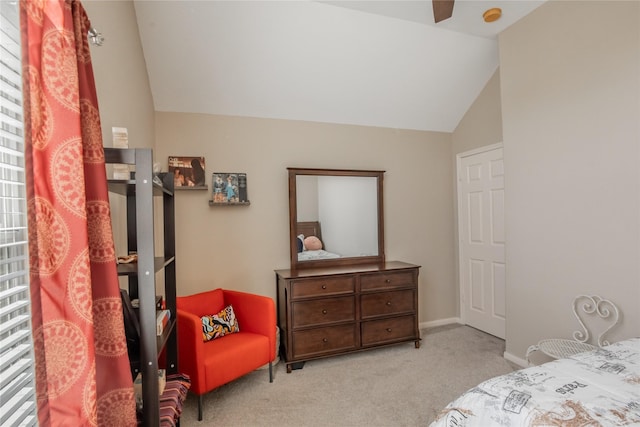 carpeted bedroom featuring baseboards and vaulted ceiling