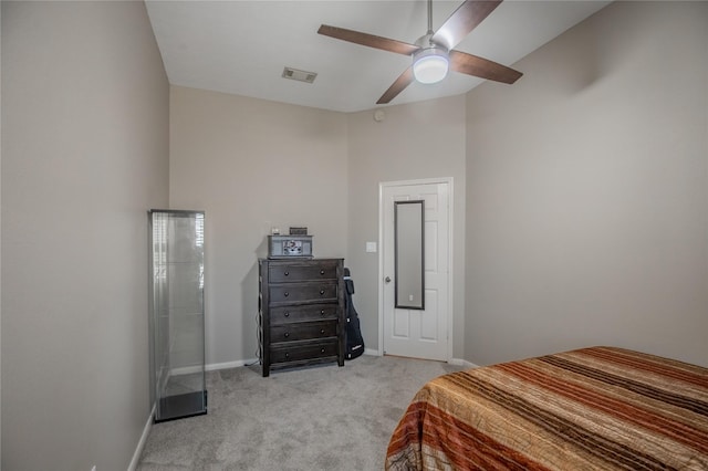 bedroom with visible vents, baseboards, ceiling fan, a towering ceiling, and light colored carpet