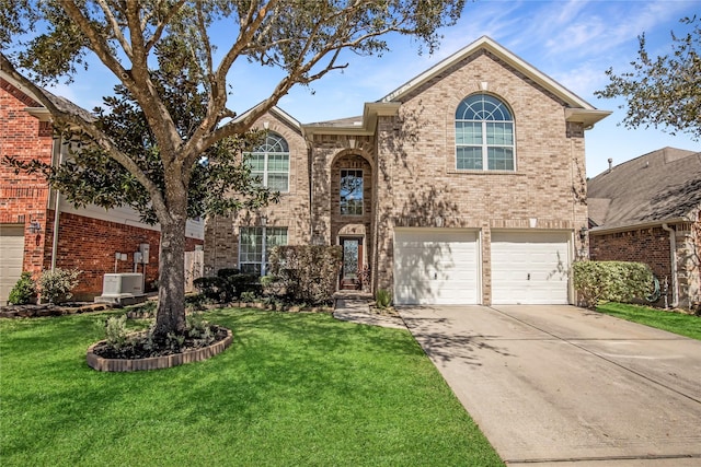 view of front of home with an attached garage, a front lawn, driveway, and brick siding