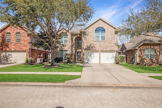 view of front of house with brick siding, driveway, a front lawn, and a garage