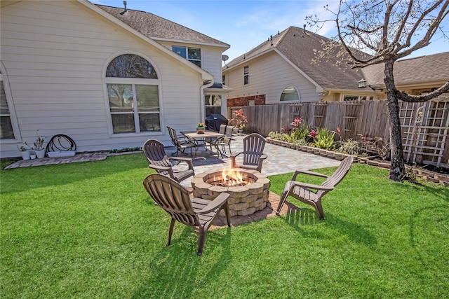 view of yard featuring an outdoor fire pit, a patio, and fence