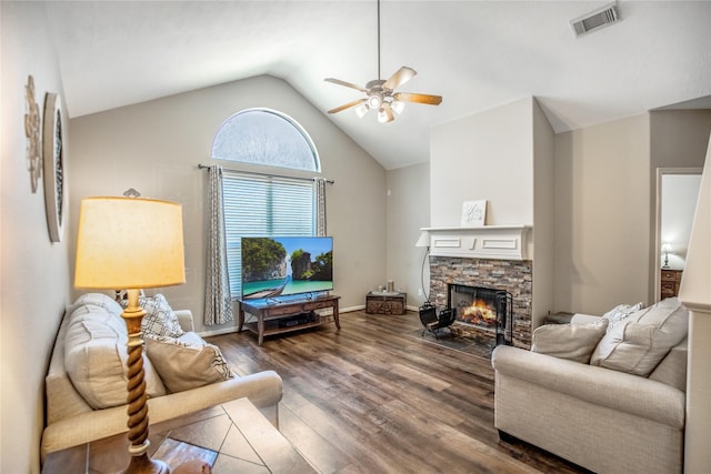 living area featuring visible vents, wood finished floors, a fireplace, lofted ceiling, and ceiling fan