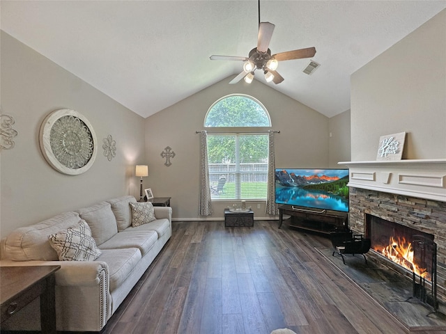 living area with a ceiling fan, dark wood-style flooring, visible vents, a fireplace, and vaulted ceiling