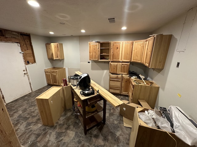 kitchen with light countertops, recessed lighting, visible vents, and open shelves