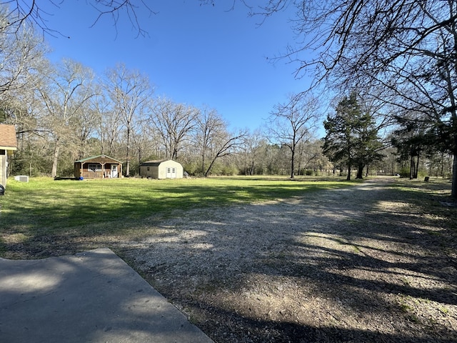1030 Mangum Rd, Livingston, TX 77351 - view of green lawn with a shed