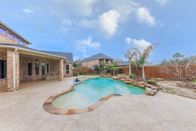 view of pool featuring a patio, a fenced backyard, a ceiling fan, and a fenced in pool