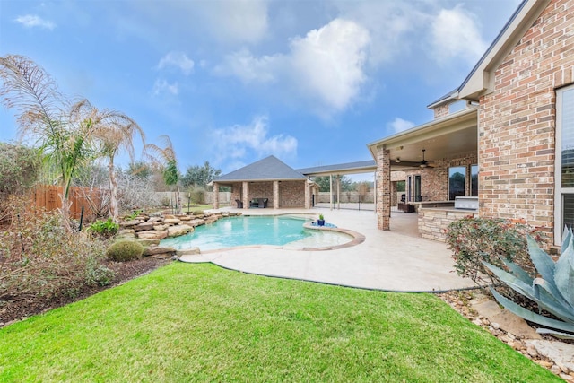 view of swimming pool featuring a ceiling fan, a fenced backyard, a lawn, and a patio