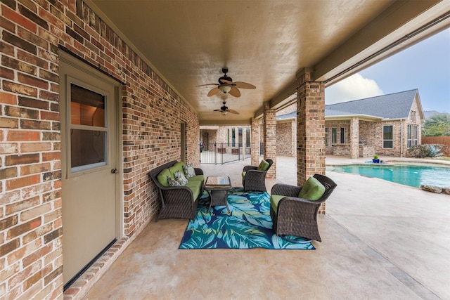 view of patio with an outdoor pool and ceiling fan