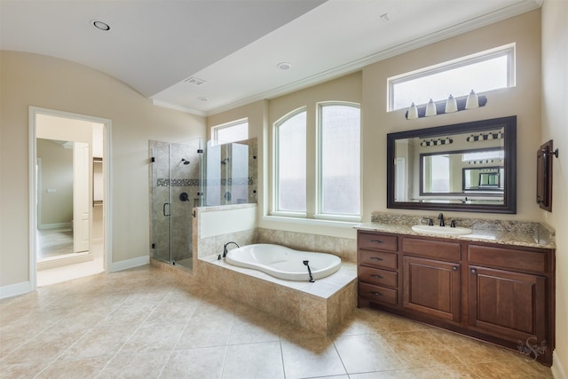 bathroom with crown molding, a stall shower, vanity, baseboards, and a bath