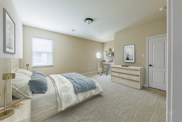 bedroom featuring light carpet, visible vents, and baseboards