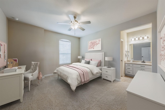 27711 Rocky Creek Ct, Fulshear, TX 77441 - bedroom with a sink, light colored carpet, ensuite bathroom, baseboards, and a ceiling fan