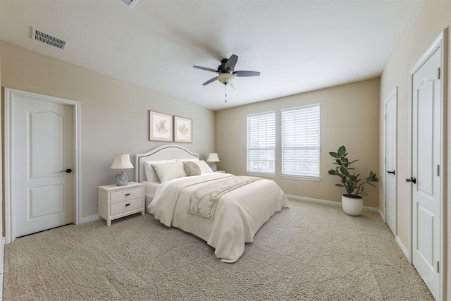 bedroom featuring light carpet, baseboards, visible vents, and ceiling fan