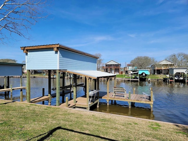 view of dock featuring a yard, a water view, and boat lift