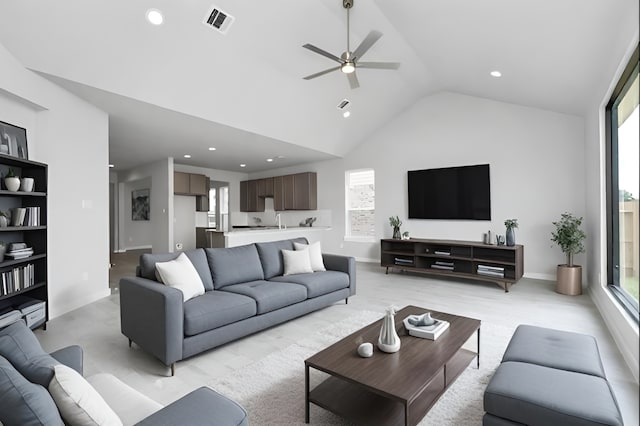 living room featuring high vaulted ceiling, visible vents, and recessed lighting