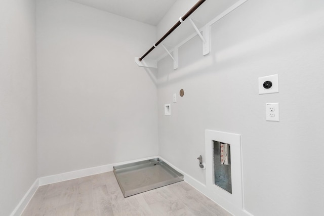 laundry room featuring washer hookup, light wood finished floors, hookup for a gas dryer, hookup for an electric dryer, and laundry area