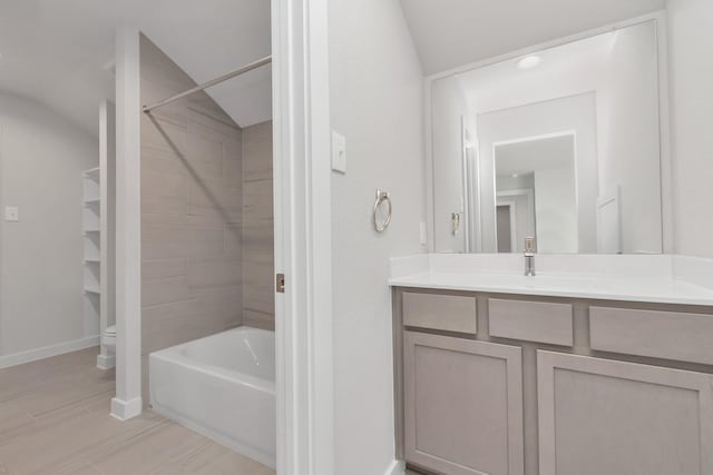 full bath with toilet, vanity, baseboards, and bathing tub / shower combination